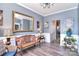 Inviting sitting area featuring stylish gray walls, wood-look flooring, and chandelier lighting at 1100 Millbank Dr, Matthews, NC 28104