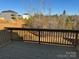 Back deck with wood railing overlooking a natural, wooded area and neighboring homes at 117 High Rock Ct # 9, Statesville, NC 28677