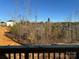 Back deck with wood railing overlooking a natural, wooded area and new construction at 117 High Rock Ct # 9, Statesville, NC 28677