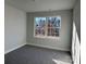 Bedroom with neutral walls and gray carpet, featuring large window at 117 High Rock Ct # 9, Statesville, NC 28677