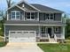 Charming two-story home featuring a spacious two-car garage, classic siding, and a welcoming front porch at 117 High Rock Ct # 9, Statesville, NC 28677