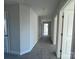 Hallway view of home featuring neutral paint, gray carpet and white doors at 117 High Rock Ct # 9, Statesville, NC 28677