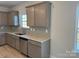 Well-lit kitchen features stainless steel appliances, gray cabinets, granite countertops, and tile backsplash at 117 High Rock Ct # 9, Statesville, NC 28677