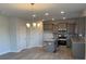 Modern kitchen with stainless steel appliances, a gray island, and ample cabinet space at 117 High Rock Ct # 9, Statesville, NC 28677