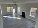 Bright living room with hardwood floors, a fireplace, and large windows offering ample natural light at 117 High Rock Ct # 9, Statesville, NC 28677