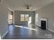 Spacious living room featuring a fireplace, modern ceiling fan, and a view to the front door at 117 High Rock Ct # 9, Statesville, NC 28677