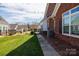 A view of the backyard of a brick townhome with manicured landscaping at 126 Adelaide Way, Rock Hill, SC 29732