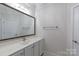 Bright bathroom featuring a marble countertop, large mirror, and white cabinets at 126 Adelaide Way, Rock Hill, SC 29732