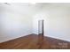 A bedroom featuring hardwood floors, a doorway to an adjacent room, and neutral walls at 126 Adelaide Way, Rock Hill, SC 29732