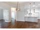 Open-concept dining area with a chandelier and view of the modern kitchen at 126 Adelaide Way, Rock Hill, SC 29732