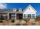 Charming brick and white facade with a black fence and manicured landscaping at 126 Adelaide Way, Rock Hill, SC 29732