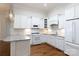 A well-lit kitchen boasts white cabinets, granite countertops, a microwave, stove, and stainless steel sink at 126 Adelaide Way, Rock Hill, SC 29732