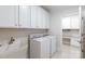 Spacious laundry room with built-in cabinets and countertops, plus washer and dryer at 126 Adelaide Way, Rock Hill, SC 29732