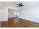 Open-concept living room with hardwood floors, white trim and a view of the kitchen at 126 Adelaide Way, Rock Hill, SC 29732