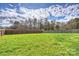 Expansive backyard featuring lush green grass, surrounded by a wooden fence for privacy and security at 12889 Clydesdale Dr # 59, Midland, NC 28107