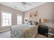 Bright bedroom with a neutral palette, comfortable bed, and two windows providing natural light at 14946 Shinner Dr, Huntersville, NC 28078