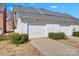 Attached garages with white doors and symmetrical shrubbery lining the driveway at 14946 Shinner Dr, Huntersville, NC 28078