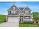 Two-story home with a front porch, two-car garage, and light blue siding at 2016 Bramble Hedge Rd # 3277, Indian Trail, NC 28079