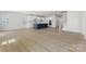 Spacious open-concept living area with hardwood floors, white walls, and a kitchen island at 2016 Bramble Hedge Rd # 3277, Indian Trail, NC 28079