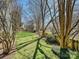 Beautiful backyard featuring a well-manicured lawn, mature trees, and picturesque landscaping at 20313 Queensdale Dr, Cornelius, NC 28031