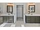 Bathroom with dual vanities, framed mirrors, and white marble countertops at 20313 Queensdale Dr, Cornelius, NC 28031