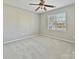 Empty bedroom featuring neutral walls, carpeted flooring, and a window at 20313 Queensdale Dr, Cornelius, NC 28031