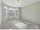 Bedroom with carpet, 3 windows with pleated blinds, and a ceiling fan at 20313 Queensdale Dr, Cornelius, NC 28031