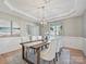 This dining room features light walls, wood floors, and a decorative ceiling with a modern light fixture at 20313 Queensdale Dr, Cornelius, NC 28031