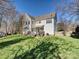 Exterior view of a well-maintained home with a spacious backyard and a wooden deck at 20313 Queensdale Dr, Cornelius, NC 28031