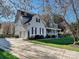 Charming two-story home with a well-manicured lawn, covered porch, and attached garage at 20313 Queensdale Dr, Cornelius, NC 28031