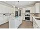 Well-appointed kitchen with white cabinetry, a central island, stainless steel appliances, and modern lighting at 20313 Queensdale Dr, Cornelius, NC 28031