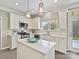 Modern kitchen featuring white cabinetry, a central island, stainless steel appliances, and stylish pendant lights at 20313 Queensdale Dr, Cornelius, NC 28031