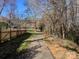 Scenic walking path adjacent to the community playground with lush greenery at 20313 Queensdale Dr, Cornelius, NC 28031