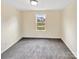 A bedroom has neutral paint, carpet floors, and a window at 217 Century Dr, Salisbury, NC 28147