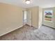 A secondary bedroom has neutral paint, carpet floors, and a window at 217 Century Dr, Salisbury, NC 28147