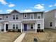 Charming townhome featuring gray siding, a covered front porch, and a well-manicured lawn at 217 Century Dr, Salisbury, NC 28147