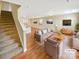 Bright living room featuring modern furnishings, hardwood floors, and an adjacent staircase at 217 Century Dr, Salisbury, NC 28147