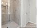 Bathroom featuring a glass shower enclosure, tiled walls, and a white door at 2308 Bulwarks Ct # 8P, Albemarle, NC 28001