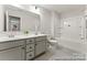 Bright bathroom with double vanity and tub shower featuring modern fixtures at 2308 Bulwarks Ct # 8P, Albemarle, NC 28001