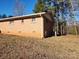 Side view of a brick house showcasing its simple design and surrounding yard at 2333 Howells Ferry Rd, Hickory Grove, SC 29717