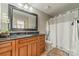 Bathroom featuring a granite vanity, decorative mirror, and shower/tub combo at 300 W 5Th St # 344, Charlotte, NC 28202