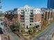 Beautiful condo building with brick and white facade, balconies, and manicured landscaping, in a desirable location at 300 W 5Th St # 344, Charlotte, NC 28202