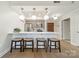 Modern kitchen with barstool seating, open to the living area with stainless appliances and hanging pendant lights at 300 W 5Th St # 344, Charlotte, NC 28202