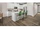 Modern kitchen featuring an island with bar seating, stainless steel appliances, and sleek white cabinetry at 3063 Finchborough Ct # 216, Charlotte, NC 28269