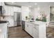 Bright kitchen with stainless steel appliances, a stylish island, and elegant pendant lighting at 3063 Finchborough Ct # 216, Charlotte, NC 28269