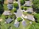 An aerial view shows homes situated around a cul-de-sac with mature trees enhancing the neighborhood's appeal at 4323 Wiregrass Rd, Indian Land, SC 29707