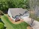 An aerial view showcases the home, its well-maintained lawn, and colorful flower beds at 4323 Wiregrass Rd, Indian Land, SC 29707
