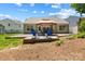 Landscaped backyard features a patio and gazebo with furniture, perfect for outdoor living at 4323 Wiregrass Rd, Indian Land, SC 29707