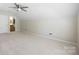 Large bedroom features neutral walls and carpet, a ceiling fan and view of a bathroom at 4323 Wiregrass Rd, Indian Land, SC 29707