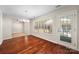 Charming dining room features wood flooring, a modern chandelier, and backyard views at 4323 Wiregrass Rd, Indian Land, SC 29707